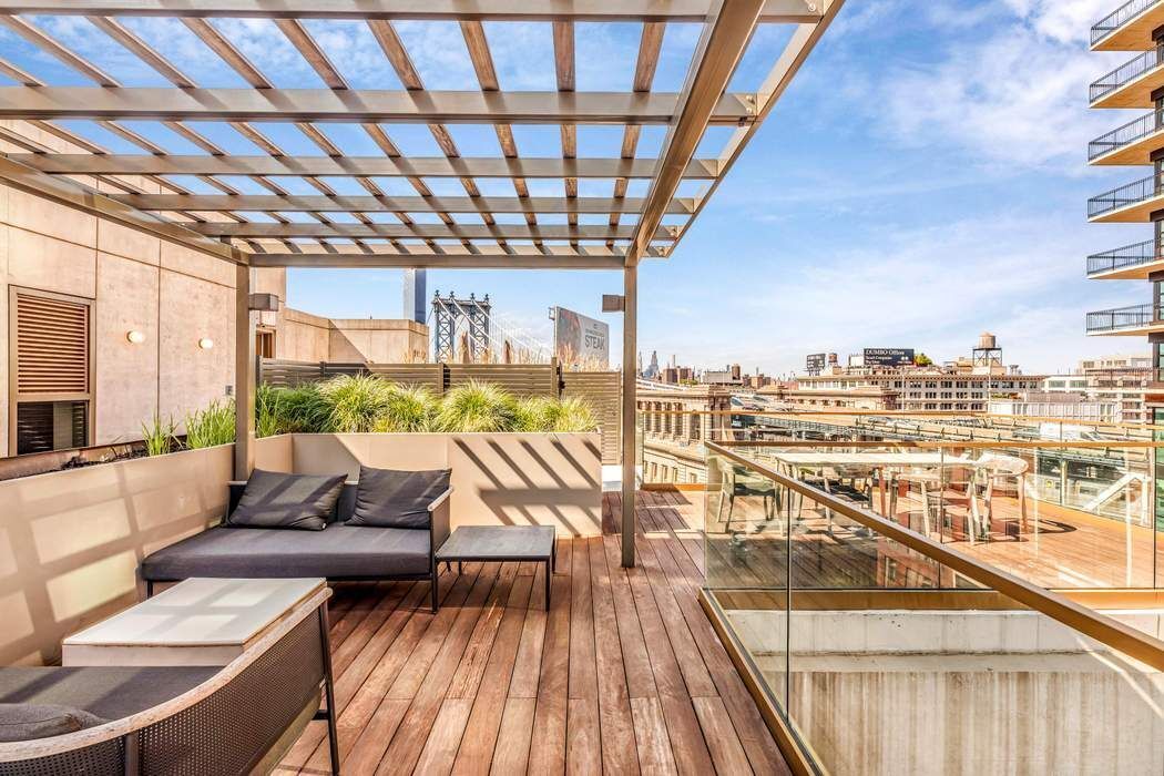 98 Front Street, Unit GRD Brooklyn, NY 11201 - Photo 19 of 23 a balcony with furniture and wooden floor