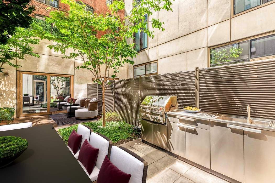 98 Front Street, Unit GRD Brooklyn, NY 11201 - Photo 3 of 23 a view of a patio with couches table and chairs and potted plants