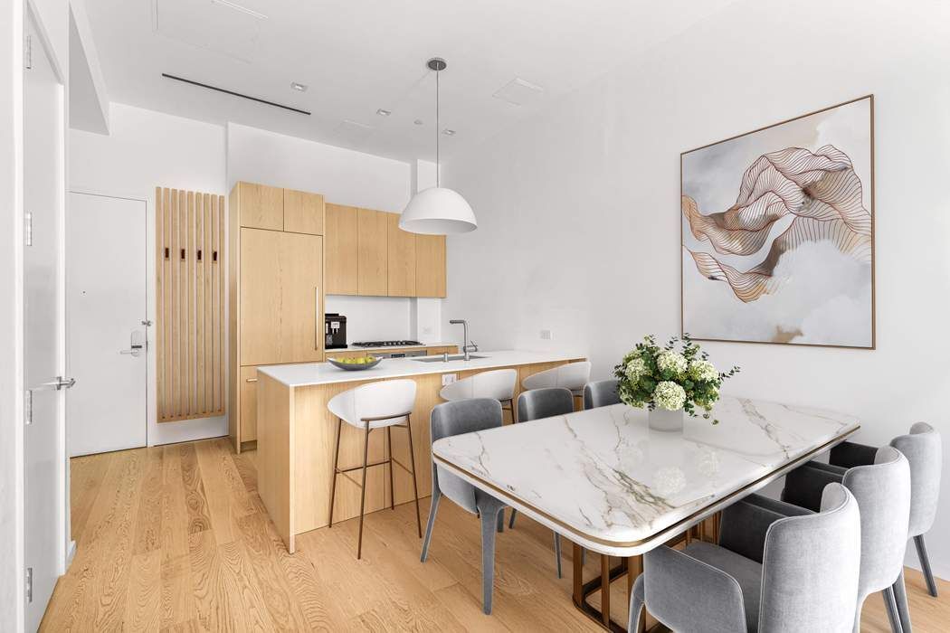 98 Front Street, Unit GRD Brooklyn, NY 11201 - Photo 5 of 23 a open kitchen with a table and chairs in it