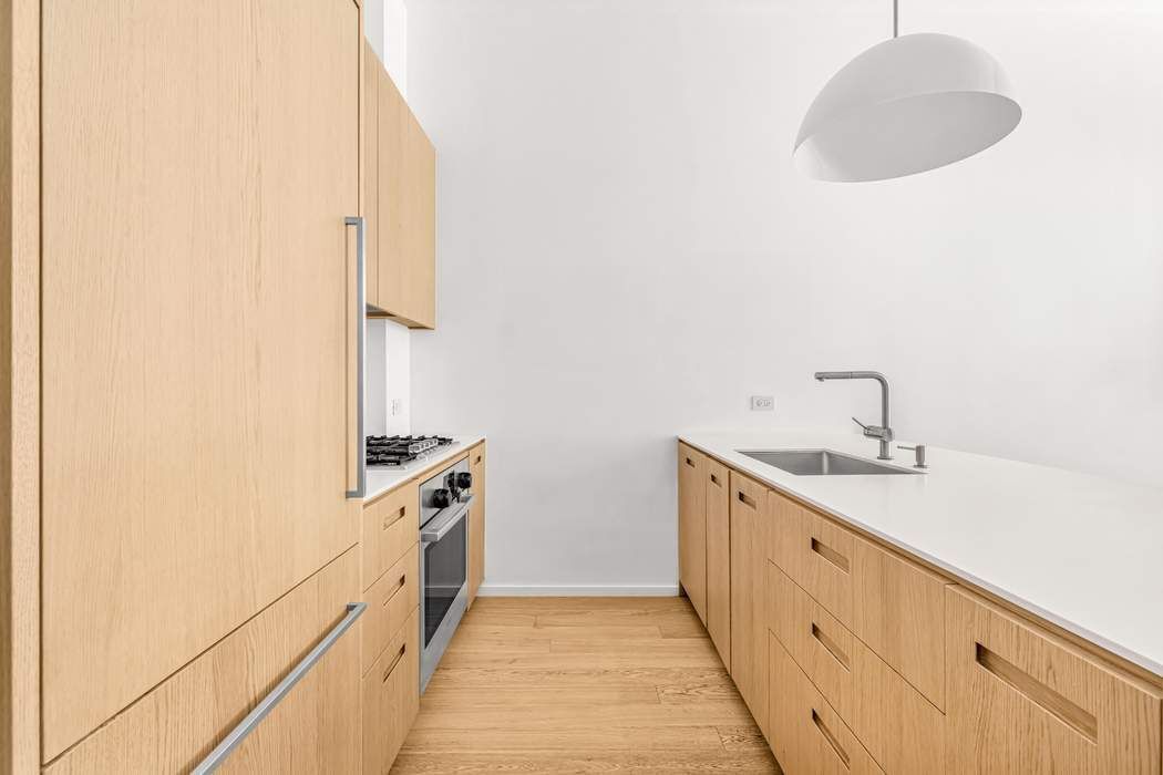 98 Front Street, Unit GRD Brooklyn, NY 11201 - Photo 6 of 23 a kitchen with a sink and cabinets