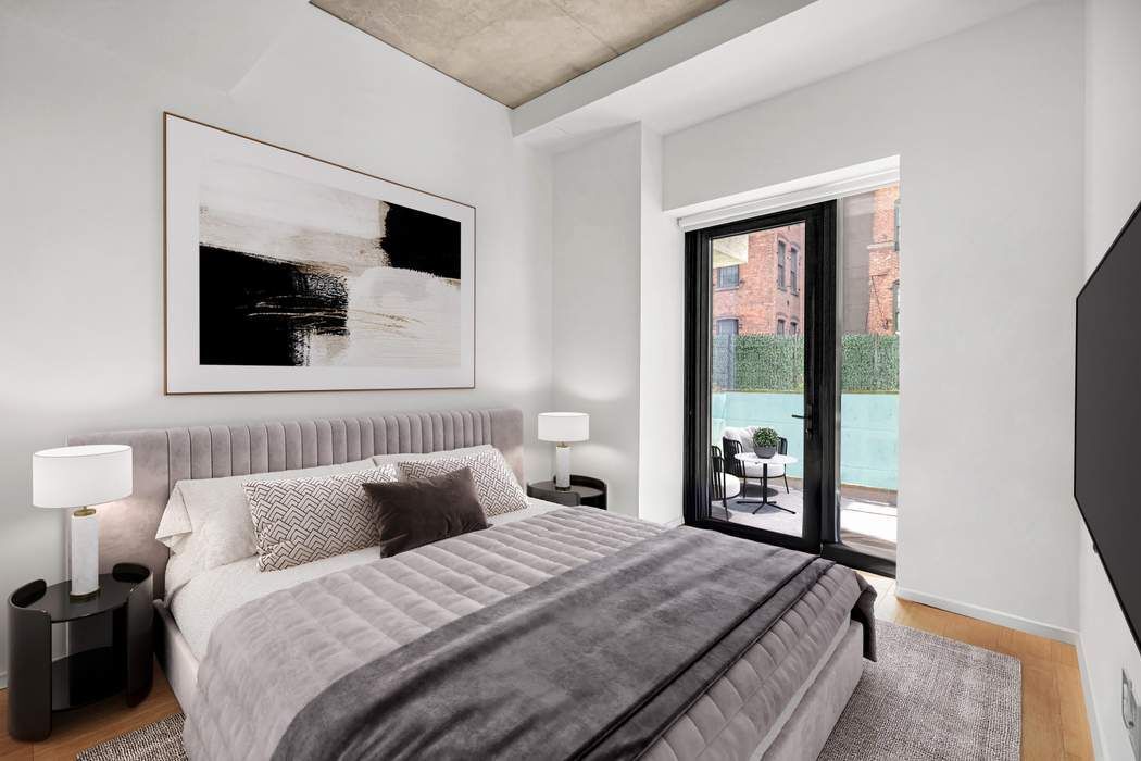 98 Front Street, Unit GRD Brooklyn, NY 11201 - Photo 7 of 23 a bedroom with a bed and a flat screen tv
