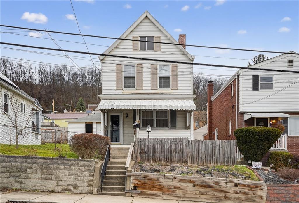 1212 Woodward Avenue McKees Rocks, PA 15136 - Photo 1 of 34 a view of a white house with large windows and a yard