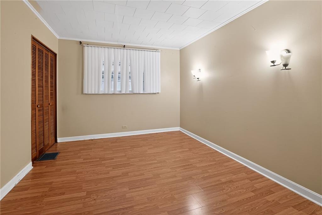 1212 Woodward Avenue McKees Rocks, PA 15136 - Photo 21 of 34 a view of an empty room with wooden floor and a window