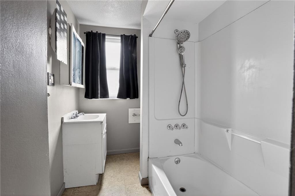 1212 Woodward Avenue McKees Rocks, PA 15136 - Photo 22 of 34 a bathroom with a tub sink and mirror