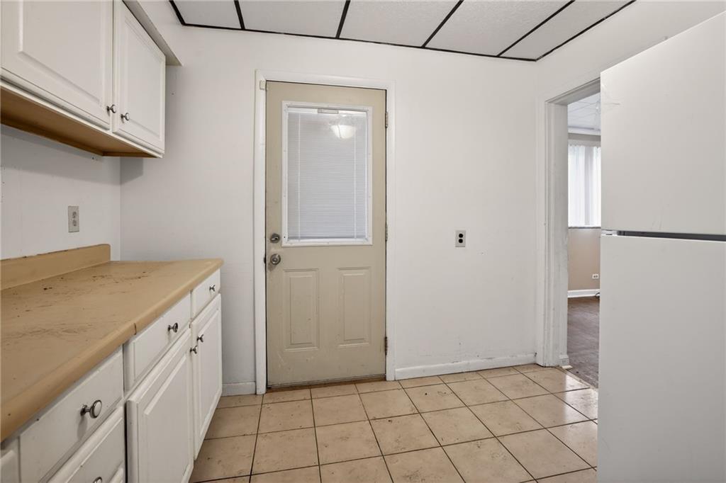 1212 Woodward Avenue McKees Rocks, PA 15136 - Photo 23 of 34 a kitchen with white cabinets and white appliances
