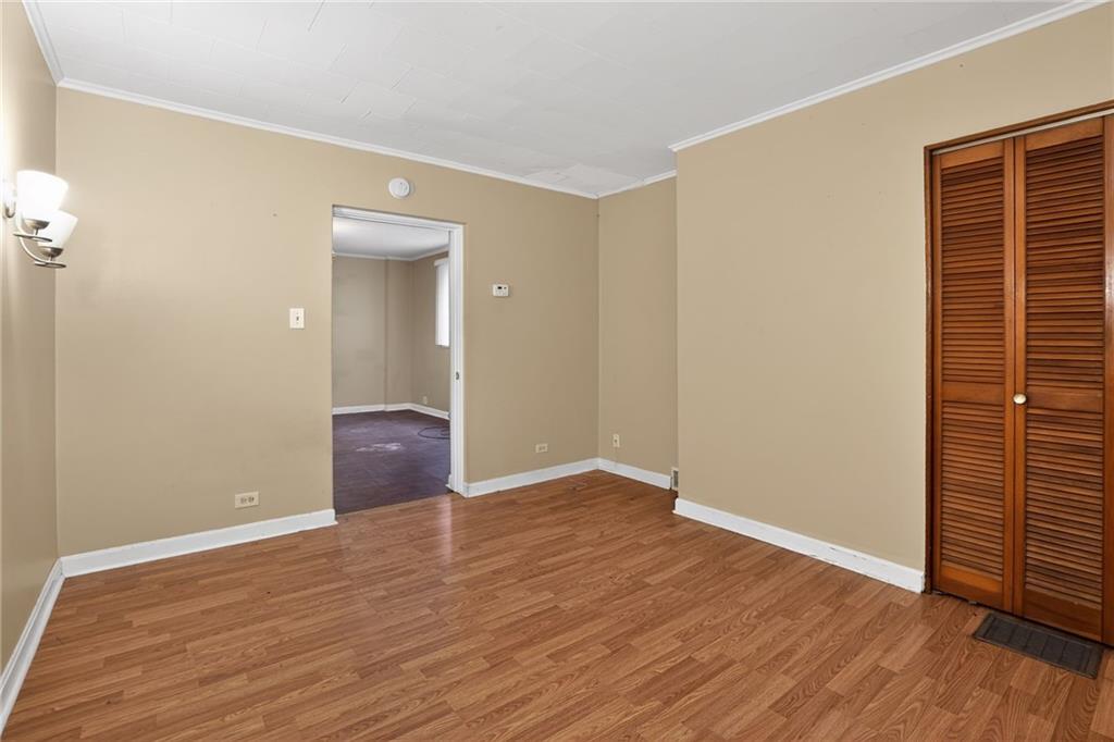 1212 Woodward Avenue McKees Rocks, PA 15136 - Photo 6 of 34 a view of an empty room with wooden floor and a window