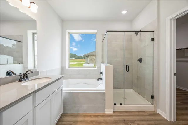 a bathroom with a granite countertop sink mirror bathtub and shower