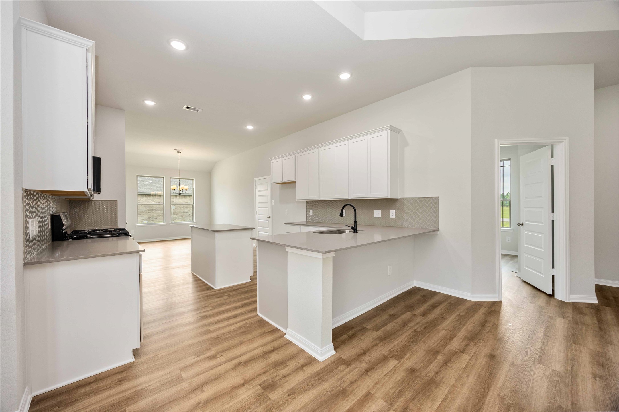 460 Barton Place Drive Cleveland, TX 77327 - Photo 10 of 27 a kitchen with a sink and wooden floor