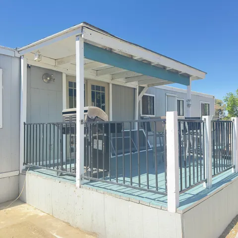 a view of a house with wooden fence