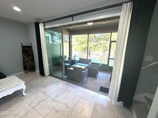 a living room with furniture and large windows