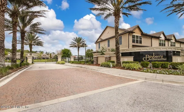 a front view of a house with a garden and plants