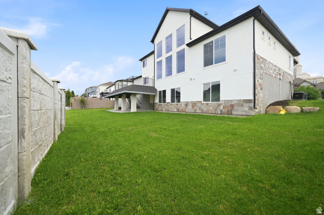 1002 West Temple Rim Lane Payson, UT 84651 - Photo 59 of 68 Expansive green lawn bordering a concrete privacy wall