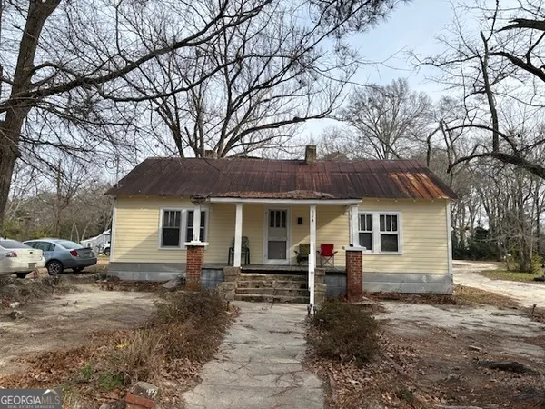 a front view of a house with yard