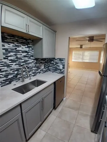 a kitchen with a sink and cabinets