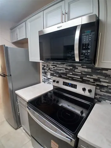 a kitchen with a stove and a microwave
