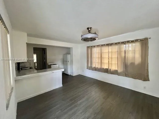 a view of a living room with hardwood floor and a window
