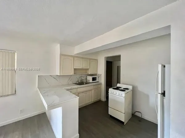 a kitchen that has a sink and a stove in it