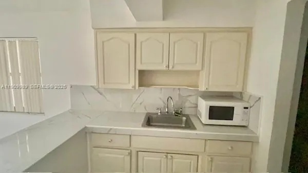 a kitchen with a sink and cabinets