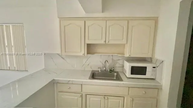a kitchen with a sink and cabinets