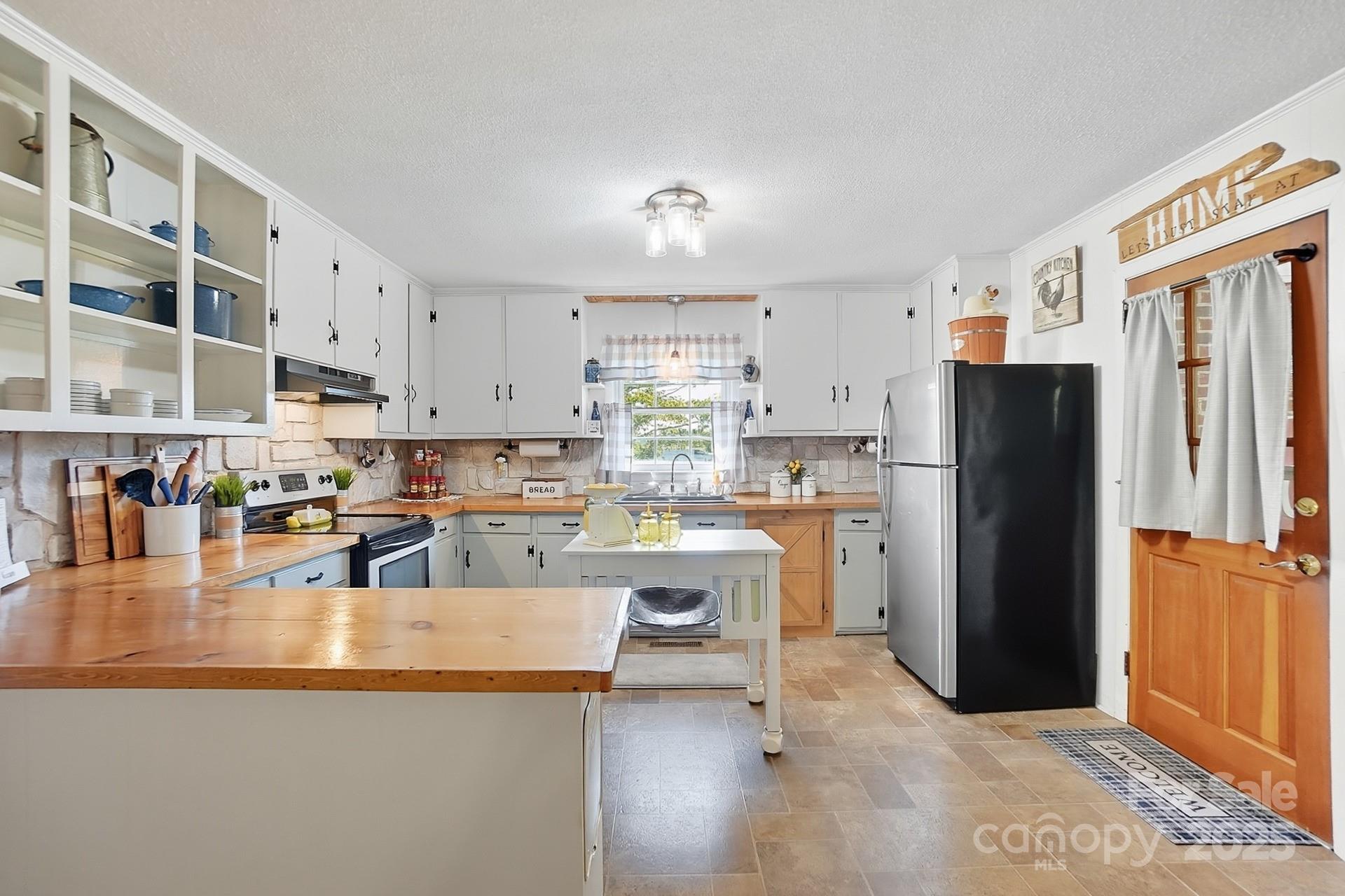 201 Airport Road Monroe, NC 28110 - Photo 11 of 47 a kitchen with stainless steel appliances granite countertop a refrigerator a stove and a sink