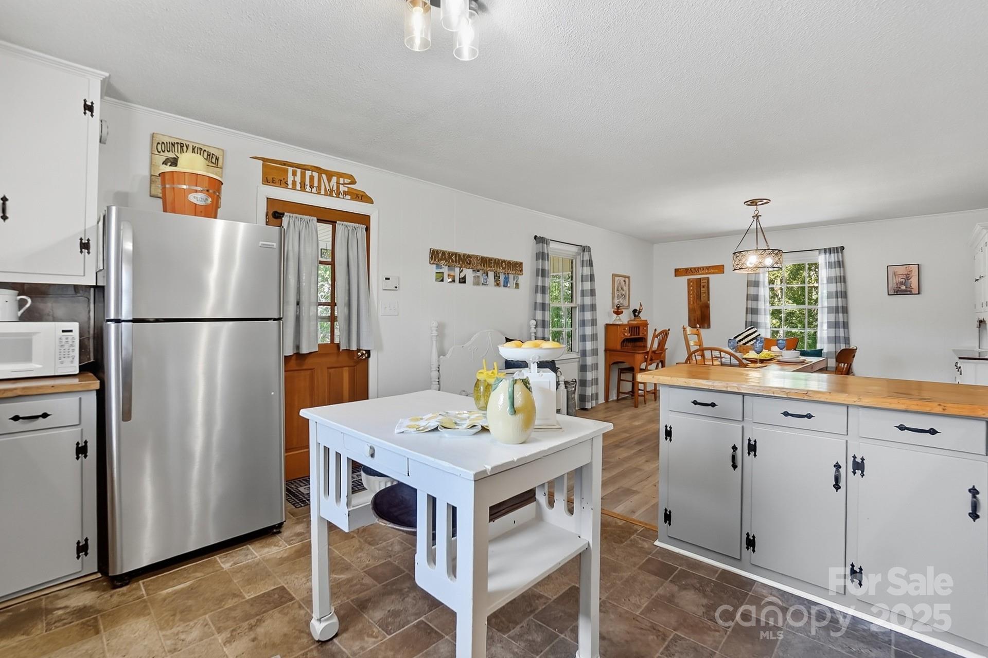 201 Airport Road Monroe, NC 28110 - Photo 13 of 47 a kitchen with a refrigerator a stove a sink dishwasher with a dining table and chairs