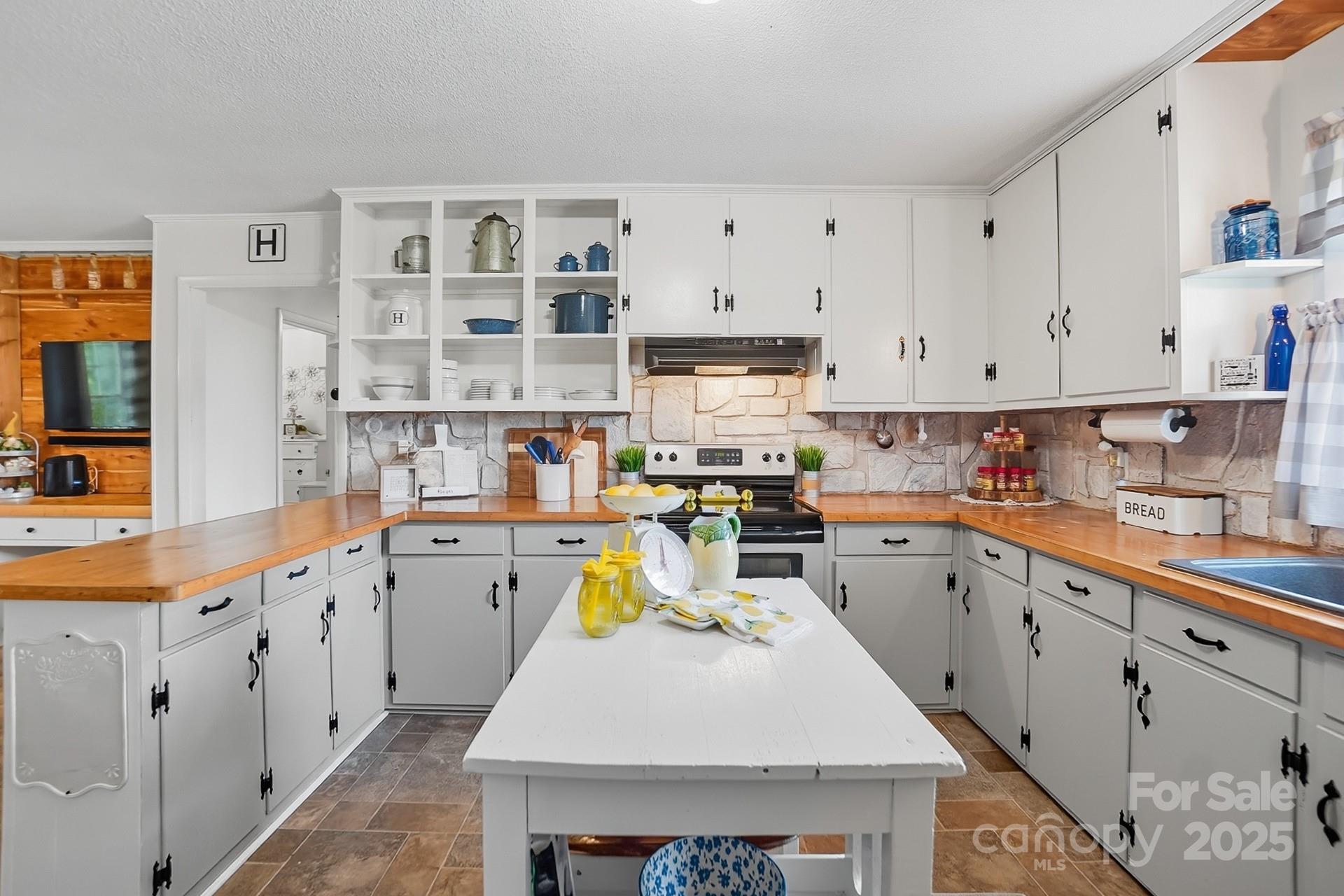 201 Airport Road Monroe, NC 28110 - Photo 16 of 47 a kitchen with cabinets and wooden floor
