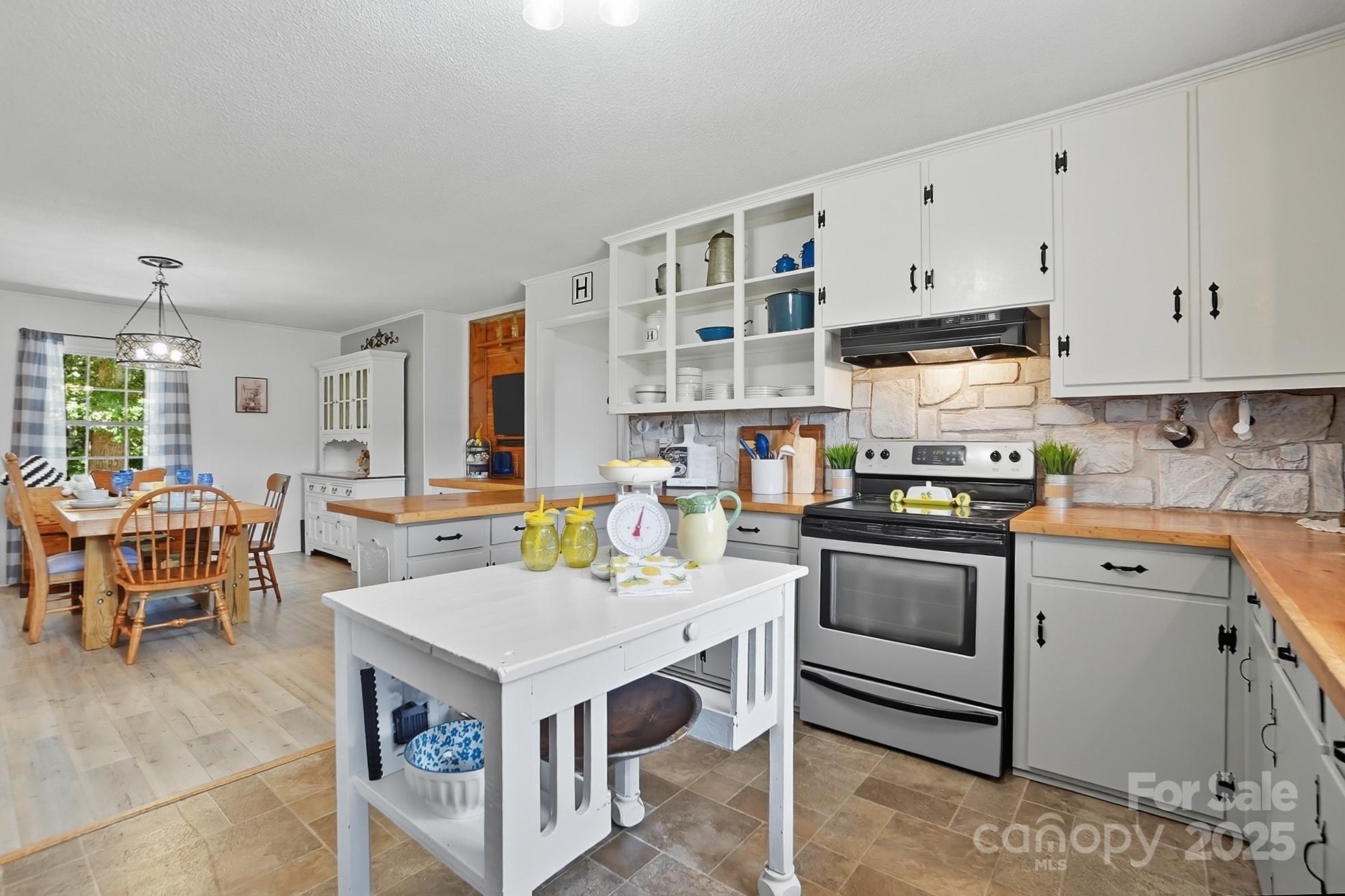 201 Airport Road Monroe, NC 28110 - Photo 17 of 47 a open kitchen with stainless steel appliances granite countertop a stove and a refrigerator