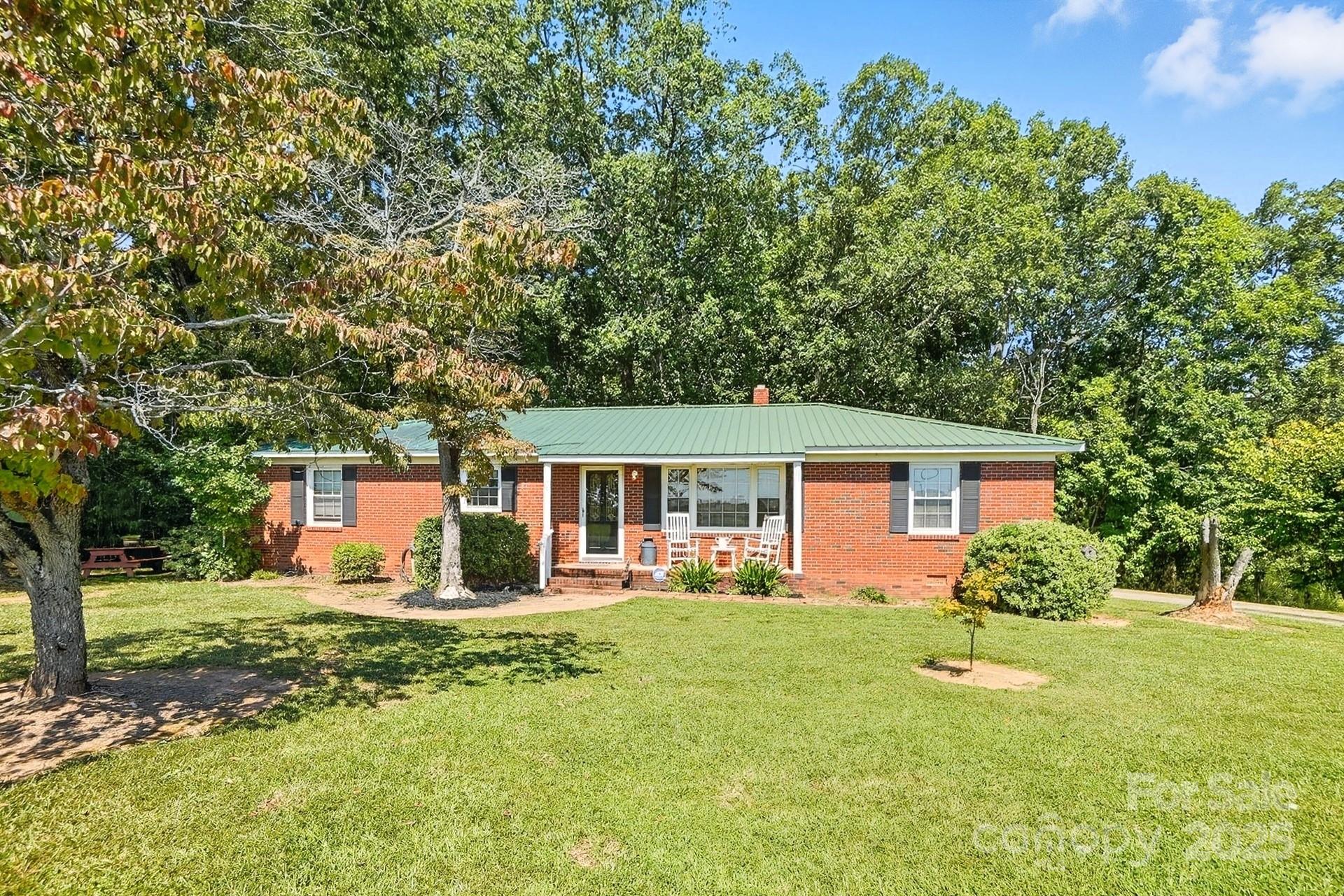 201 Airport Road Monroe, NC 28110 - Photo 2 of 47 a front view of house with yard and trees in the background