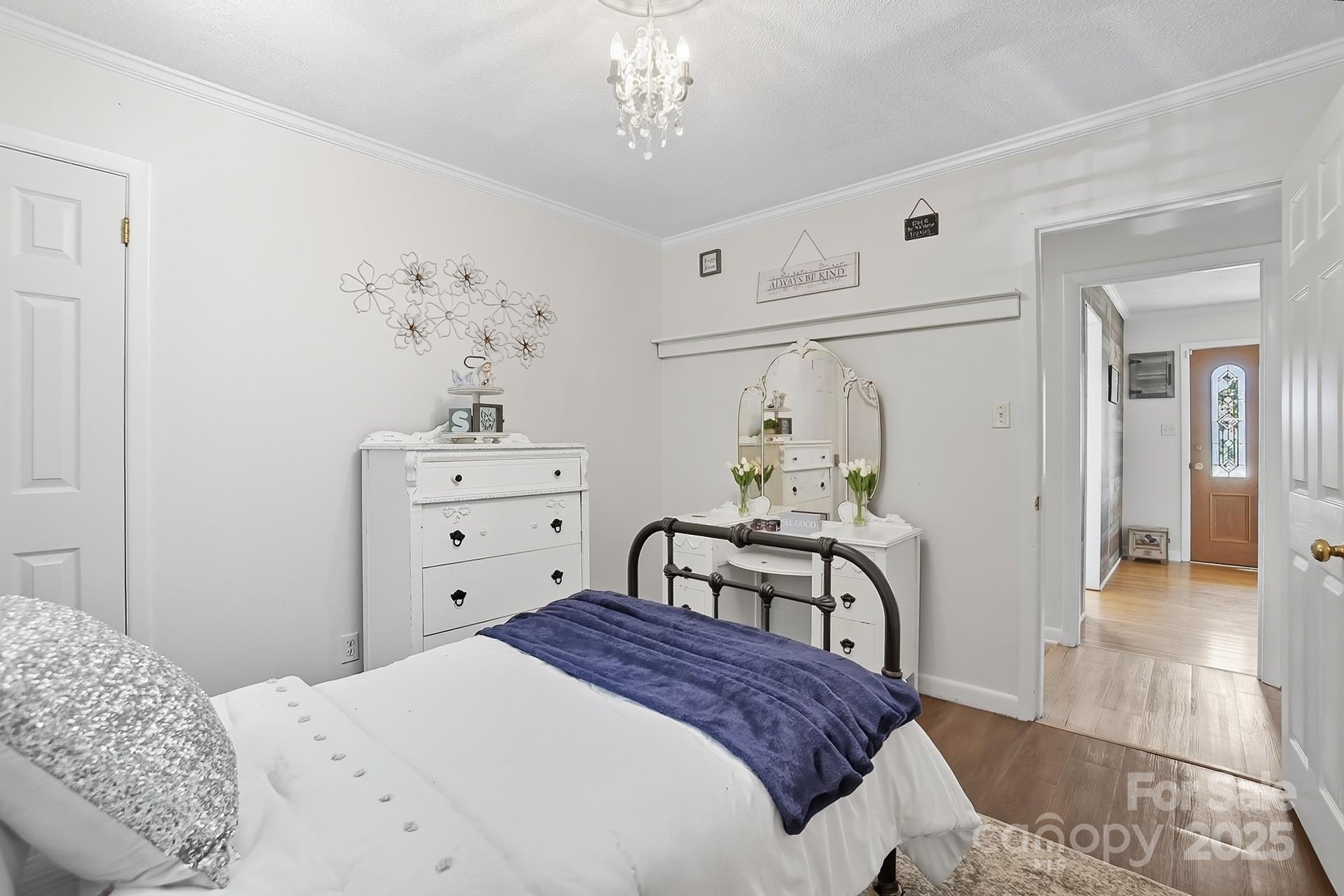 201 Airport Road Monroe, NC 28110 - Photo 27 of 47 a bedroom with a bed and a chandelier