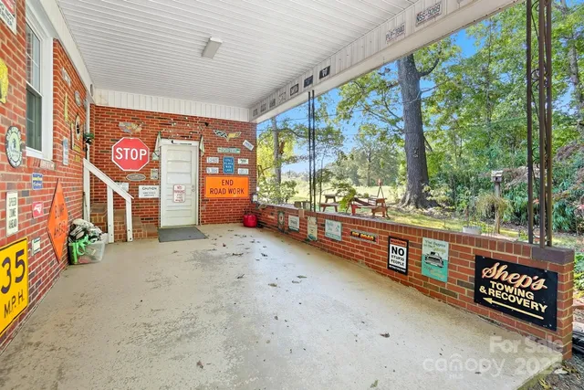 a view of a backyard with table and chairs under an umbrella
