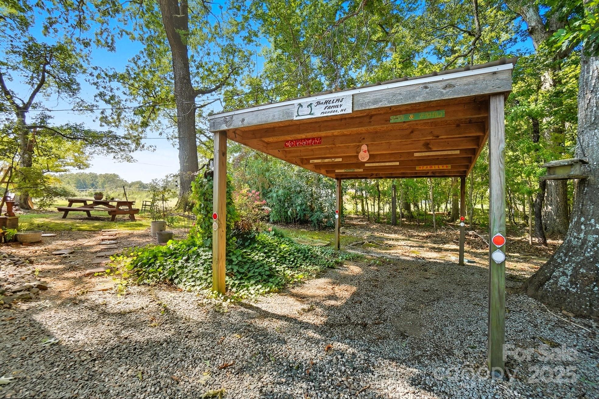 201 Airport Road Monroe, NC 28110 - Photo 34 of 47 a view of a backyard with table and chairs under an umbrella