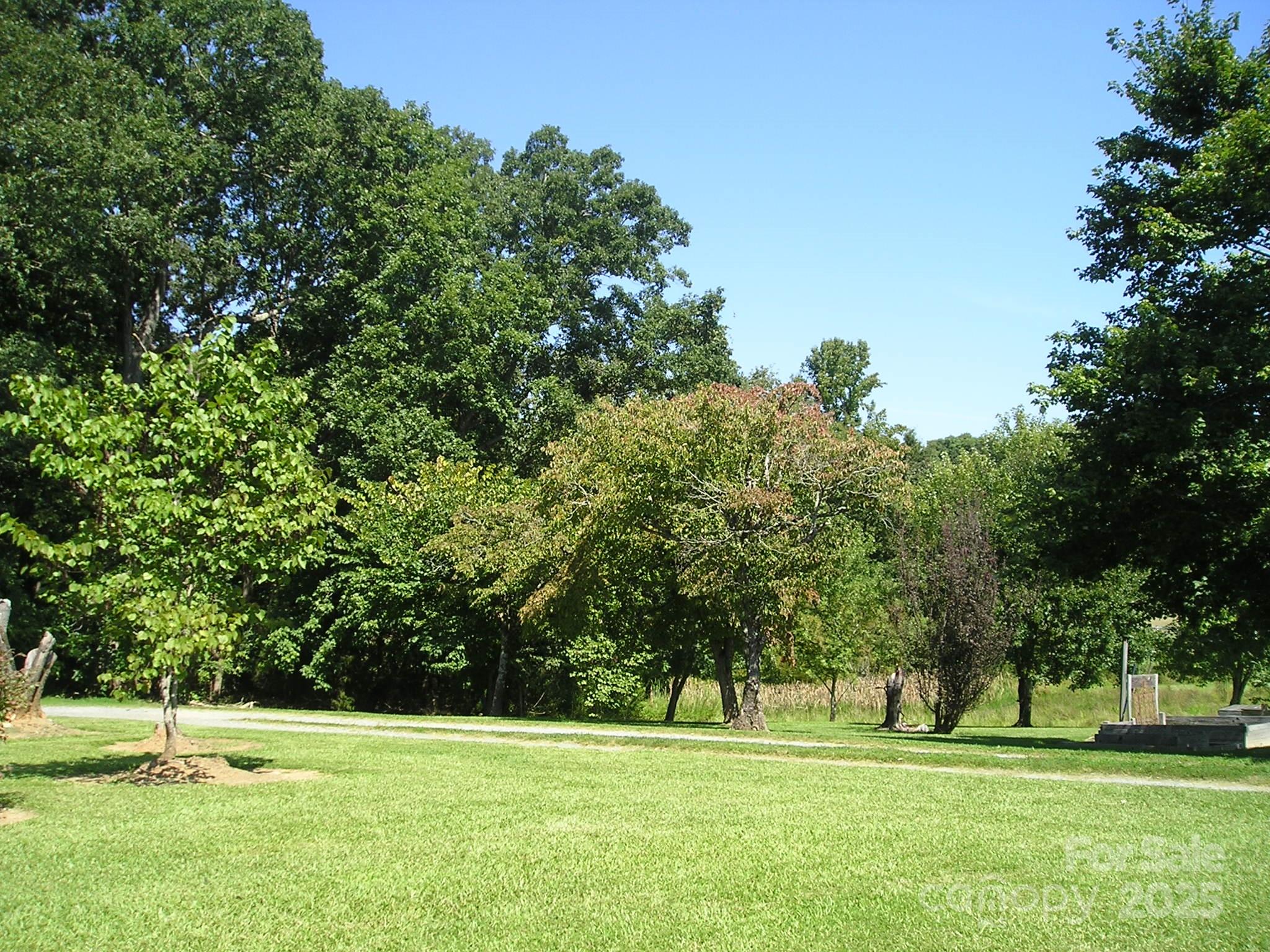 201 Airport Road Monroe, NC 28110 - Photo 43 of 47 a grassy field with trees in the background