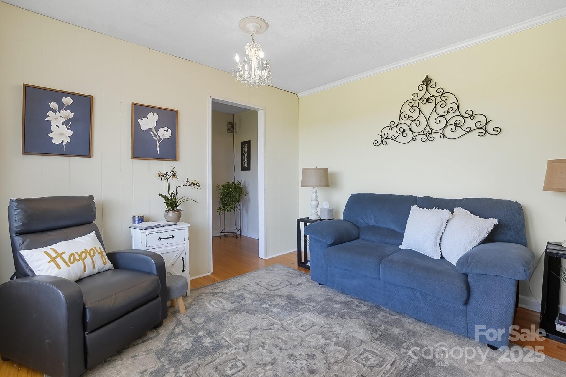 201 Airport Road Monroe, NC 28110 - Photo 8 of 47 a living room with furniture and a chandelier