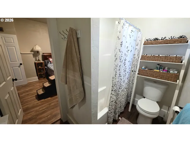 a bathroom with a toilet and a shower curtain