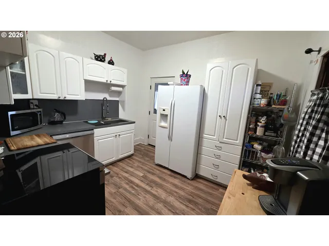 a kitchen with a refrigerator and cabinets