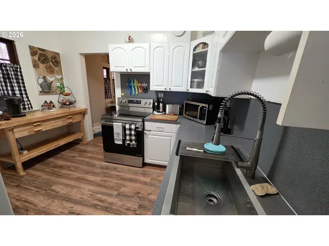 a kitchen with stainless steel appliances kitchen island granite countertop a refrigerator and a stove