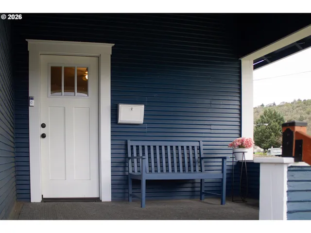 a view of a balcony with a potted plant and a window