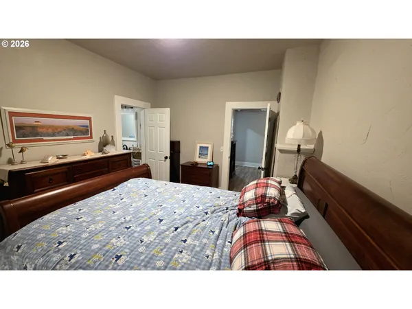 a living room with a bed and a dresser