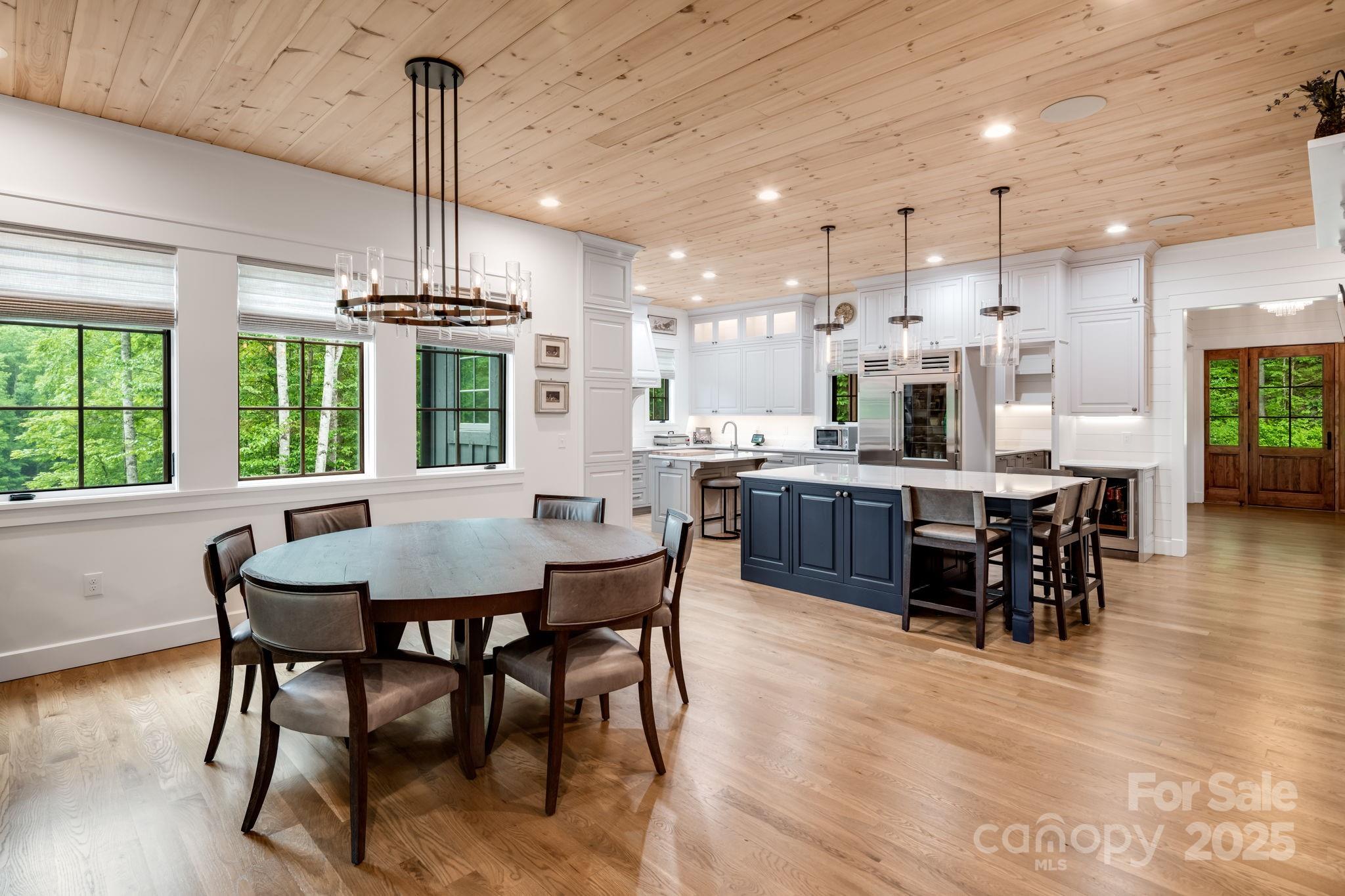 1416 East Clubhouse Road, Unit 73 Sylva, NC 28779 - Photo 13 of 48 a view of a dining room and livingroom with furniture wooden floor a chandelier