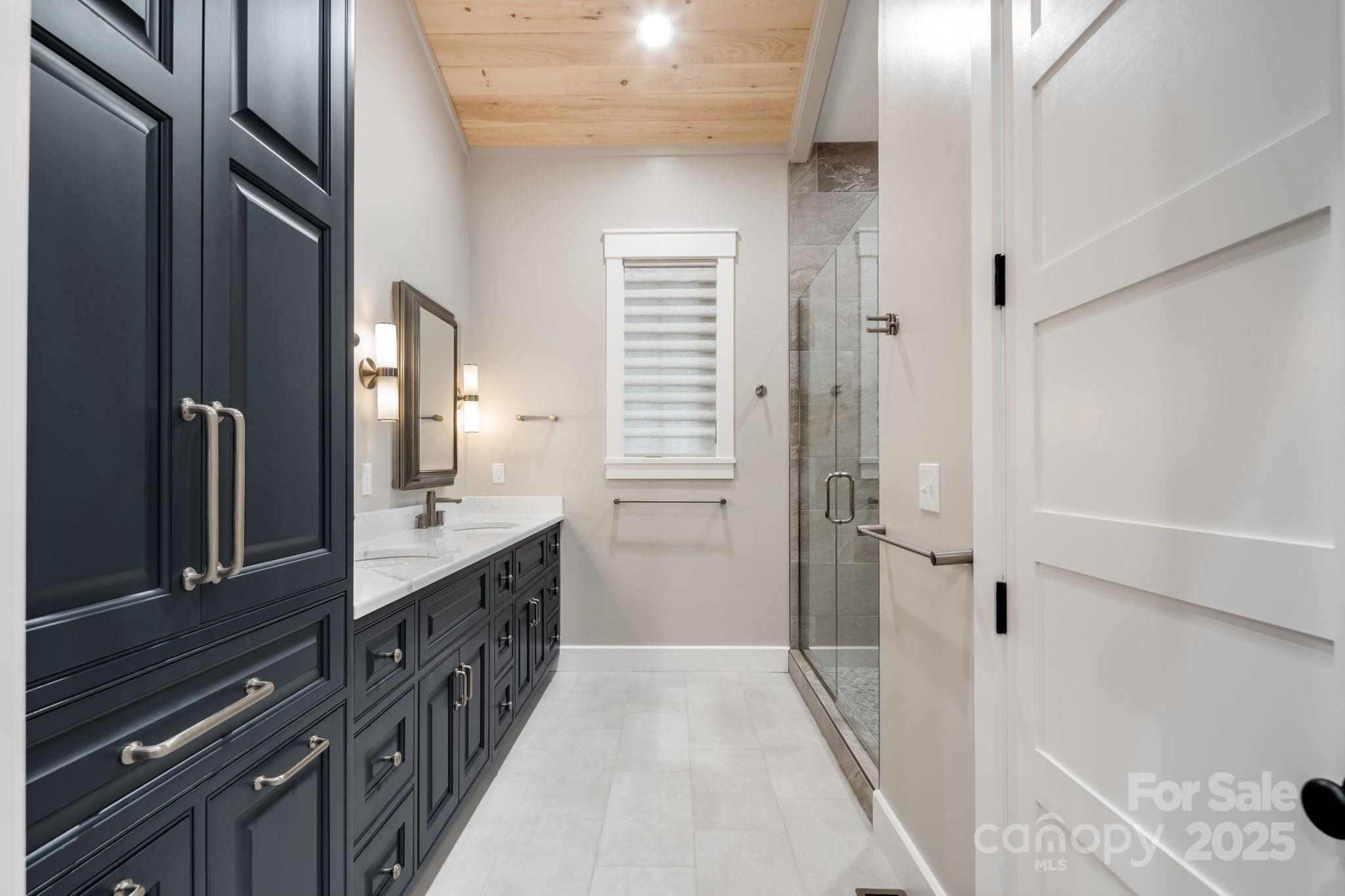 1416 East Clubhouse Road, Unit 73 Sylva, NC 28779 - Photo 22 of 48 a bathroom with a double vanity sink a and a shower