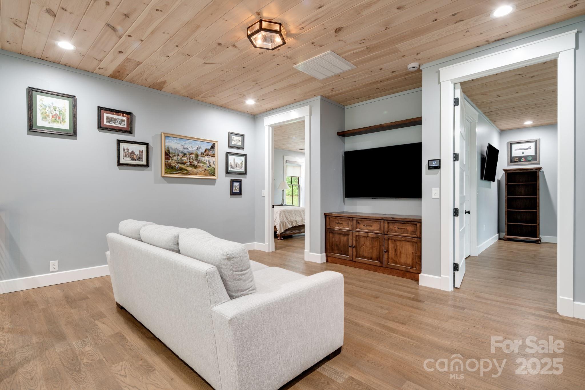 1416 East Clubhouse Road, Unit 73 Sylva, NC 28779 - Photo 24 of 48 a living room with furniture and a flat screen tv