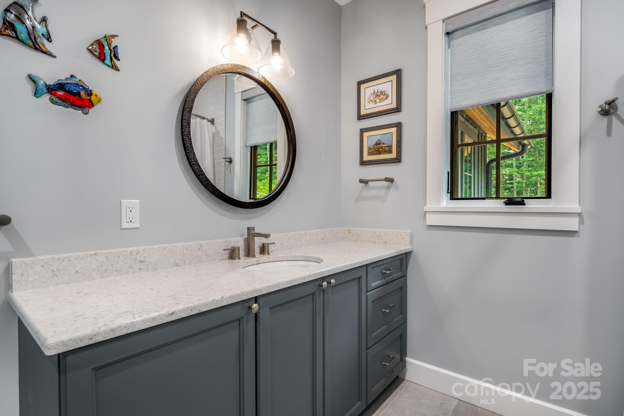 1416 East Clubhouse Road, Unit 73 Sylva, NC 28779 - Photo 30 of 48 a bathroom with a granite countertop sink and a mirror