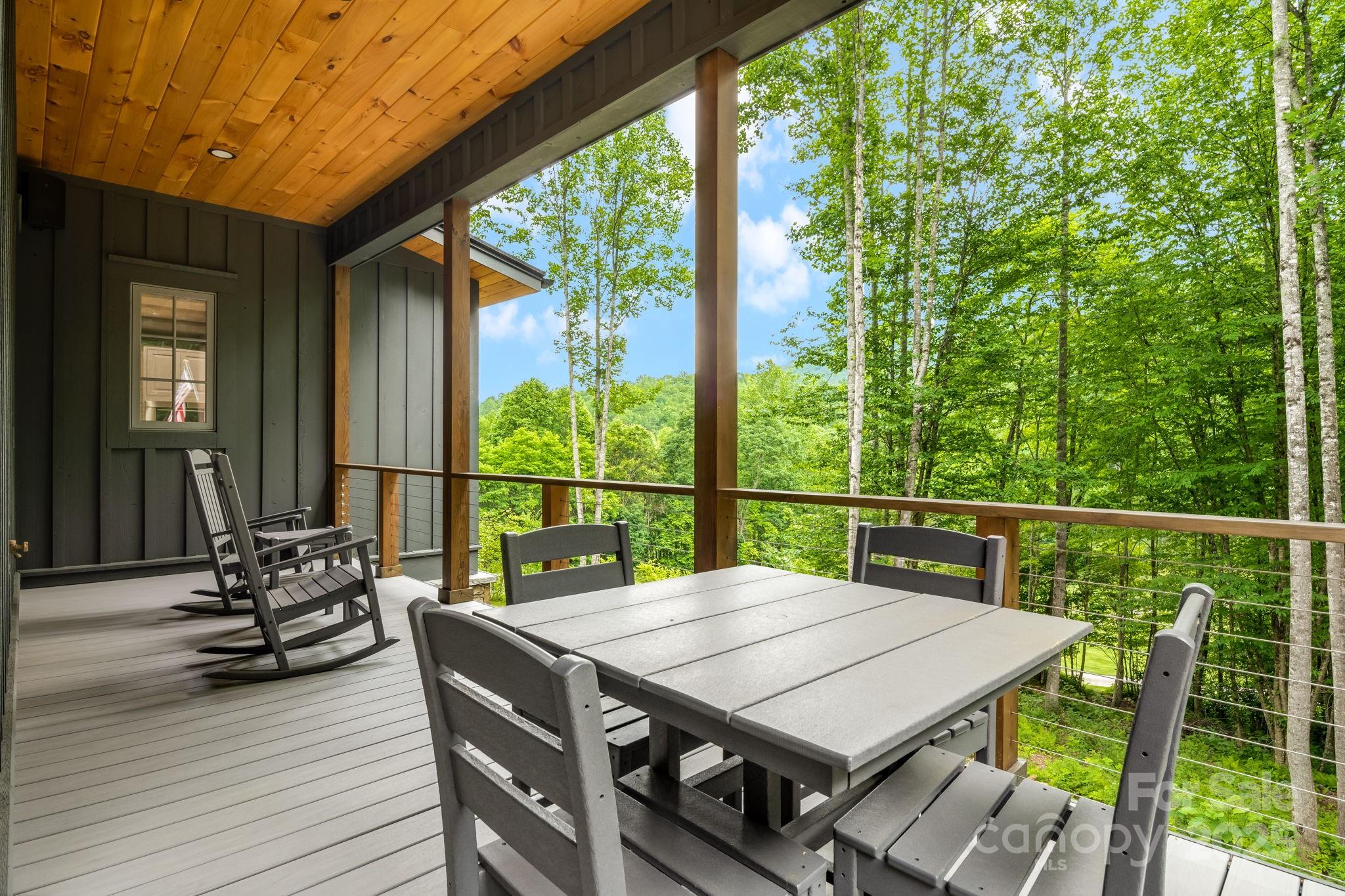 1416 East Clubhouse Road, Unit 73 Sylva, NC 28779 - Photo 35 of 48 a view of deck with table and chairs with wooden floor and fence