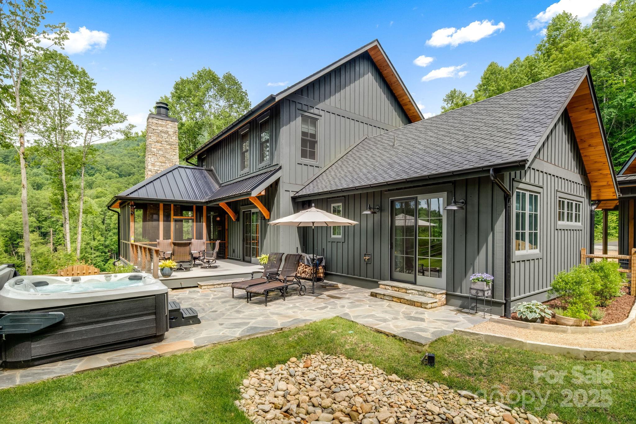 1416 East Clubhouse Road, Unit 73 Sylva, NC 28779 - Photo 4 of 48 a patio with a table and chairs under an umbrella