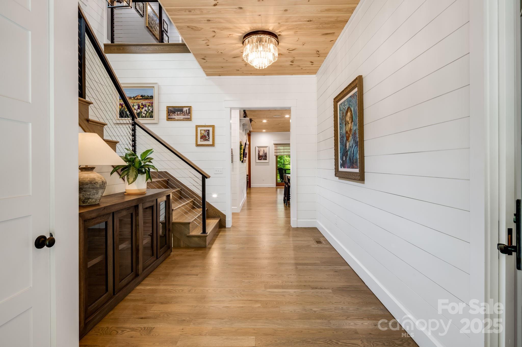 1416 East Clubhouse Road, Unit 73 Sylva, NC 28779 - Photo 8 of 48 a hallway with wooden floor and staircase