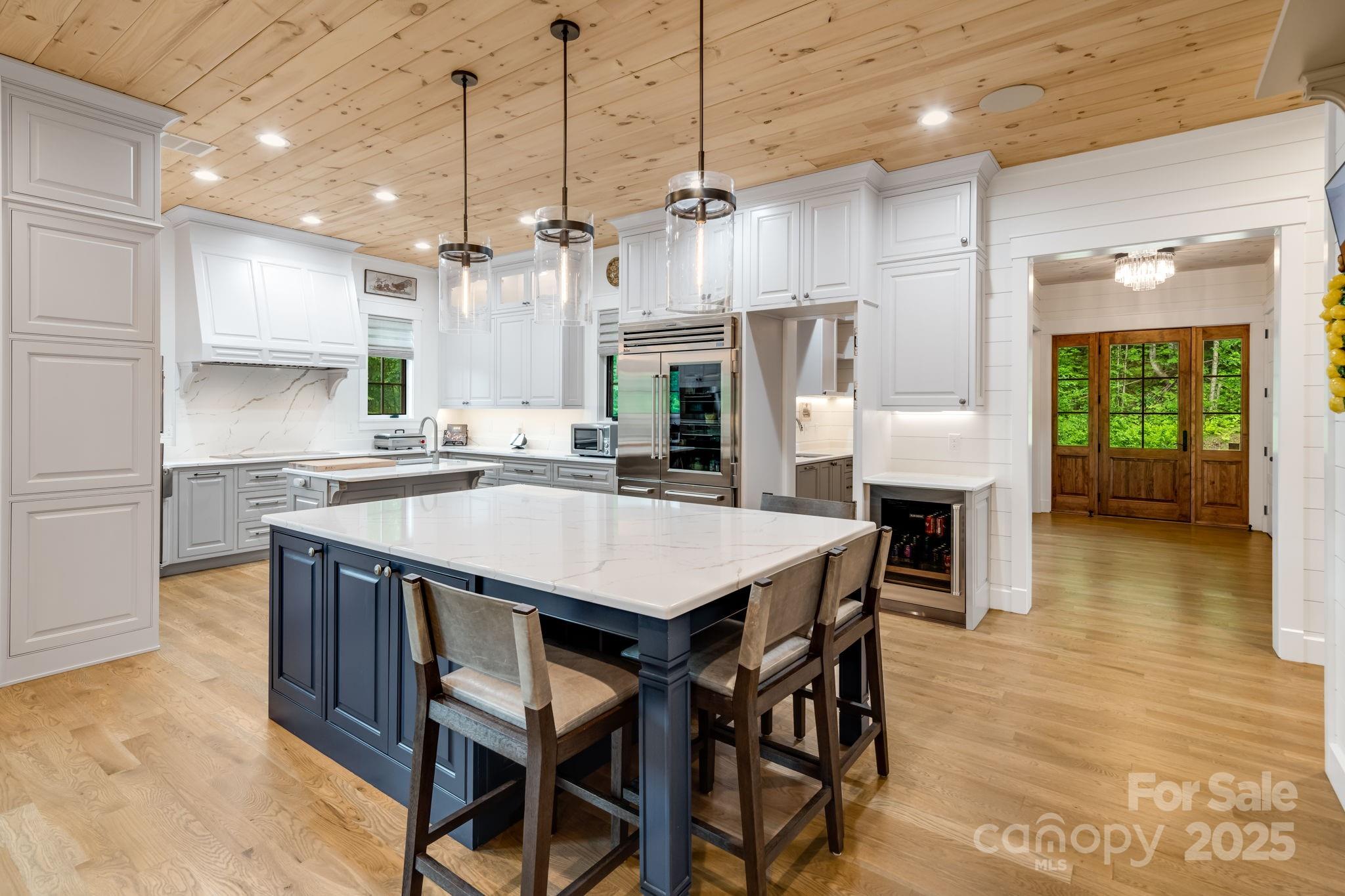 1416 East Clubhouse Road, Unit 73 Sylva, NC 28779 - Photo 9 of 48 a kitchen with granite countertop a table chairs stainless steel appliances and wooden floor