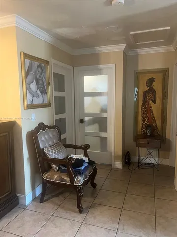 a living room with furniture a window and a painting on the wall