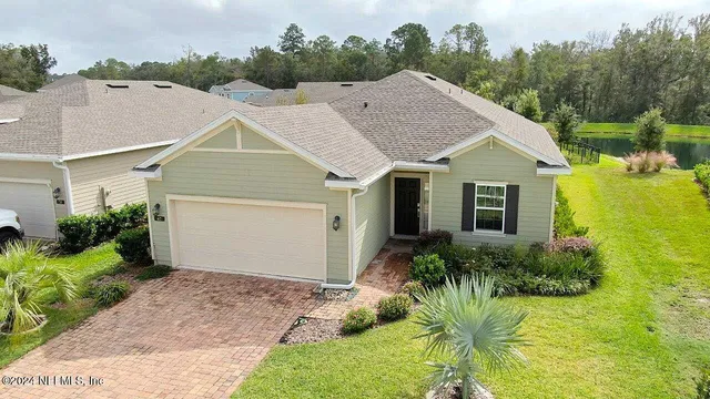 a aerial view of a house with a yard and potted plants