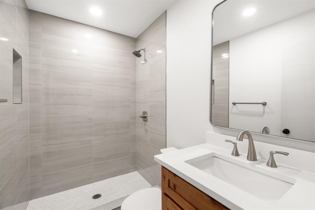 103 North Summit Street Red Oak, TX 75154 - Photo 13 of 26 a bathroom with a sink shower and a mirror