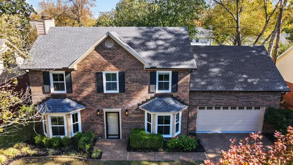 a view of a big room with wooden floor and windows